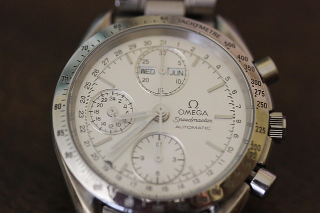 Omega Speedmaster Moonwatch on a man's wrist inside a car